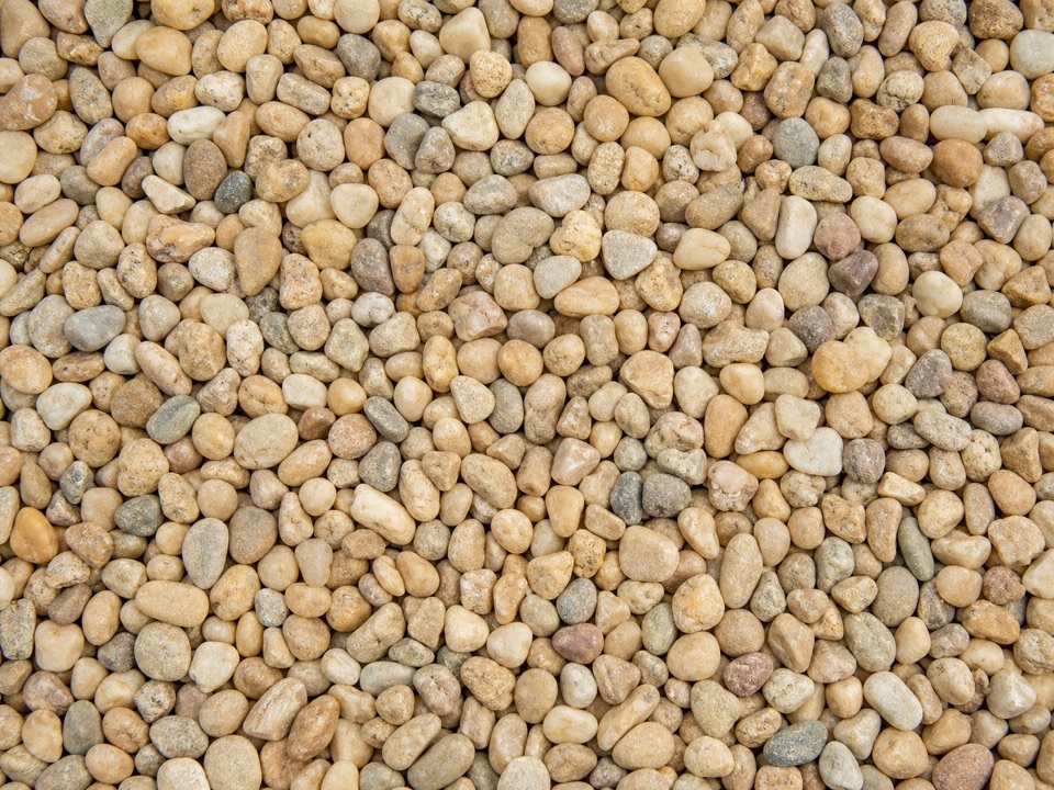 Close-up of tan rounded pea gravel stones